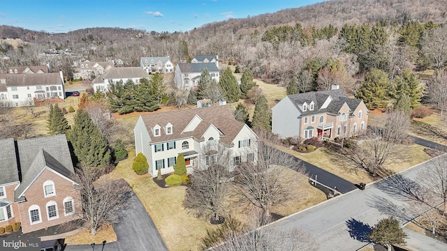 bird's eye view featuring a residential view and a forest view