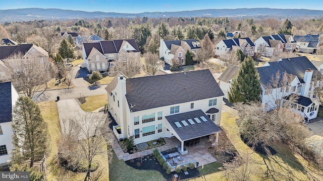 bird's eye view featuring a residential view and a wooded view