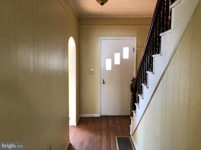 foyer entrance featuring visible vents, stairs, and wood finished floors