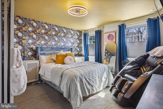 bedroom with wallpapered walls and carpet flooring