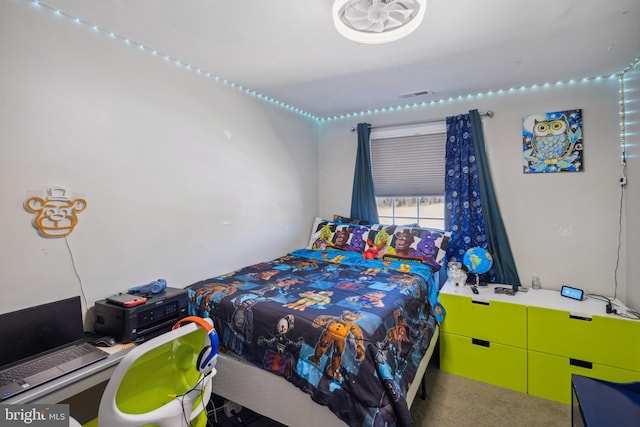 carpeted bedroom featuring visible vents