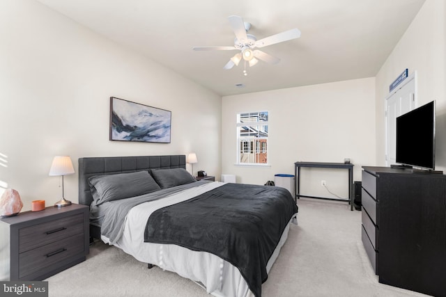 bedroom featuring light colored carpet and ceiling fan