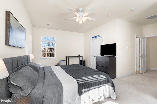 bedroom featuring visible vents, light colored carpet, baseboards, and ceiling fan