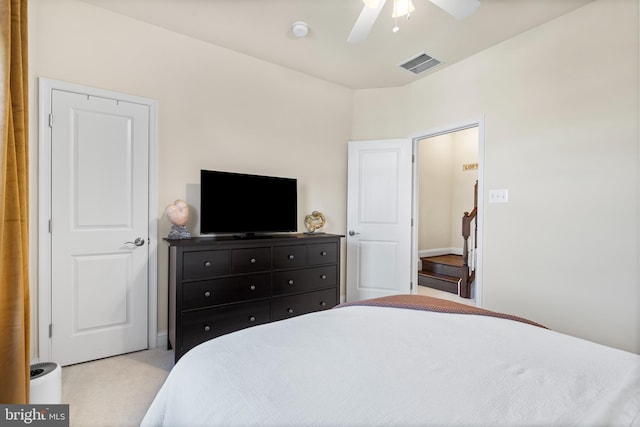 carpeted bedroom featuring visible vents and a ceiling fan