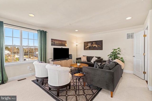 living room with recessed lighting, visible vents, and light carpet