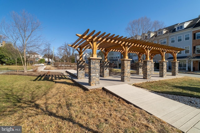 view of community with a pergola and a yard