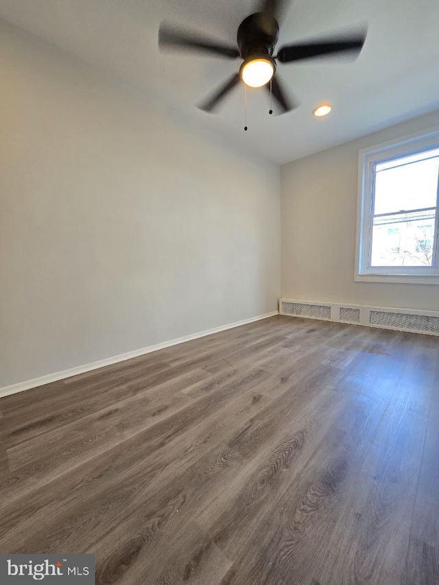 spare room with recessed lighting, baseboards, a ceiling fan, and wood finished floors