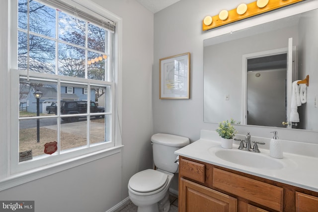 bathroom featuring toilet and vanity