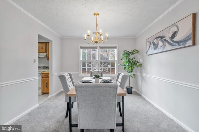 dining room featuring a chandelier, light colored carpet, a textured ceiling, and baseboards