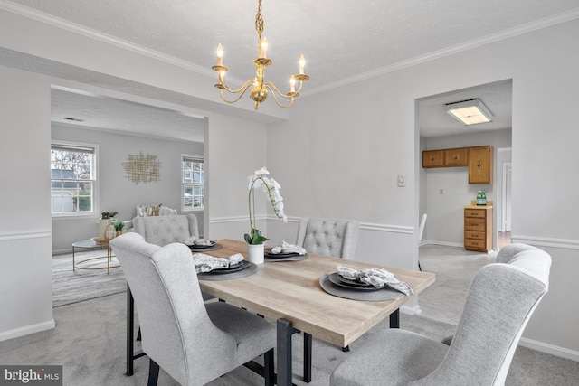 dining space featuring baseboards, a chandelier, ornamental molding, light carpet, and a textured ceiling