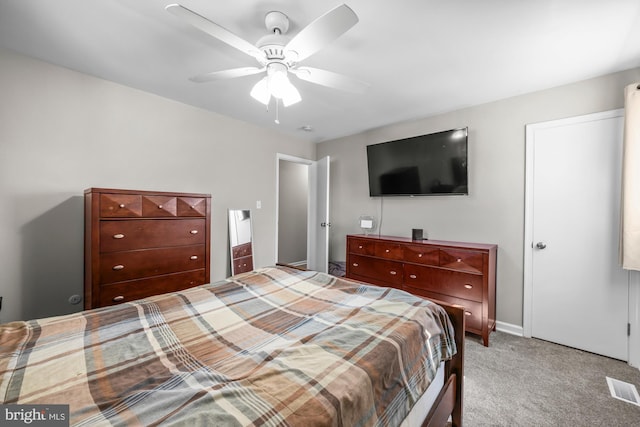 carpeted bedroom with visible vents and a ceiling fan