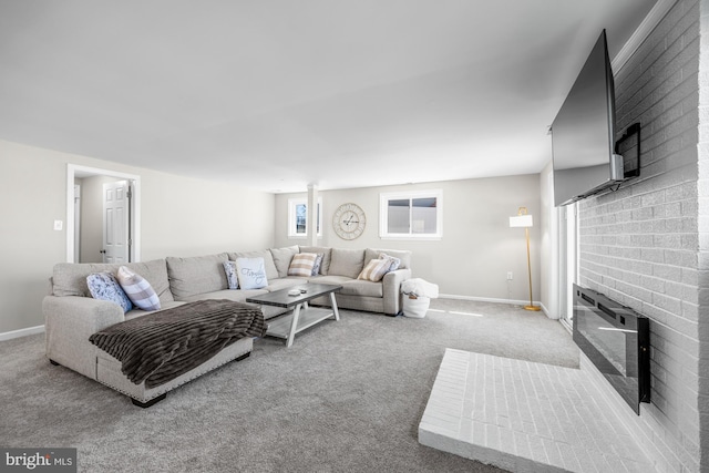 carpeted living area featuring baseboards and a fireplace