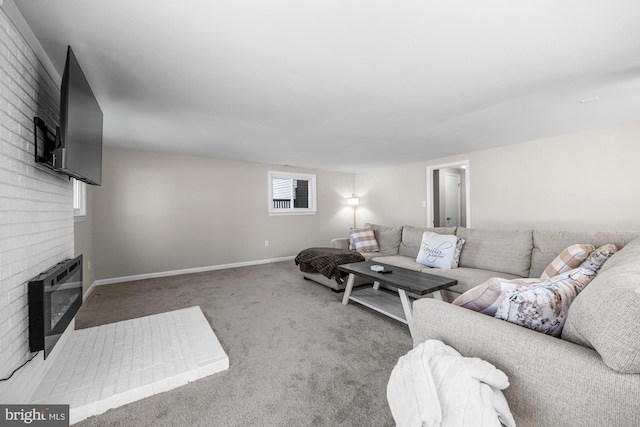 carpeted living area with a brick fireplace, heating unit, and baseboards