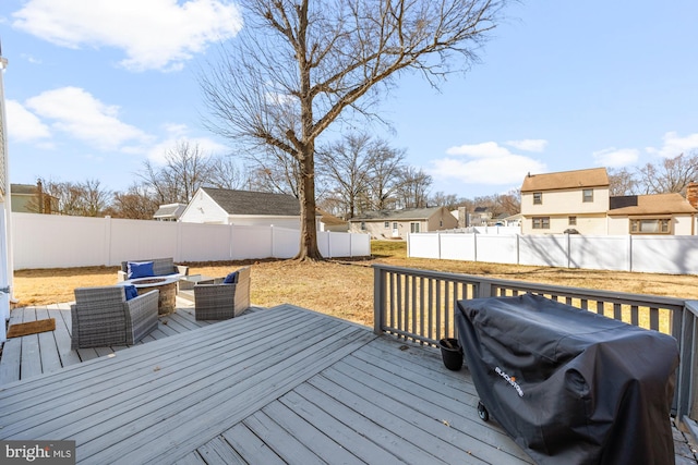 deck featuring a residential view, a grill, an outdoor hangout area, and a fenced backyard