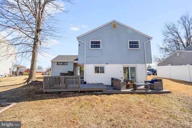 back of house featuring outdoor lounge area, fence, a lawn, and a wooden deck