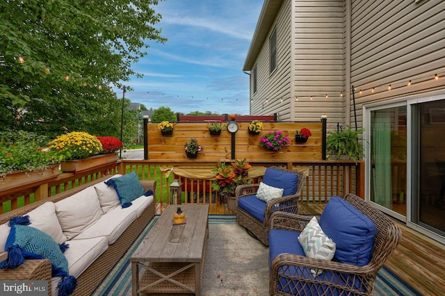 wooden terrace with an outdoor living space