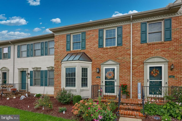 townhome / multi-family property featuring brick siding