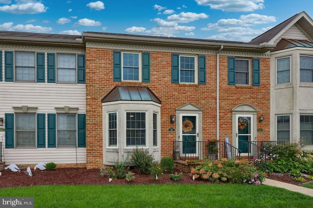 view of property featuring brick siding