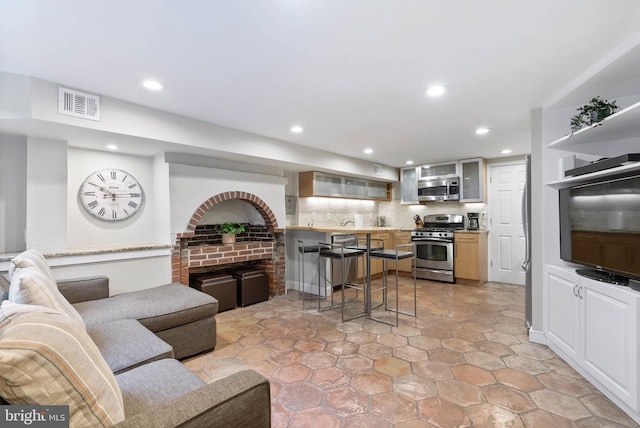 living room with visible vents and recessed lighting