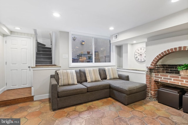 living area featuring visible vents, a brick fireplace, baseboards, stairs, and recessed lighting