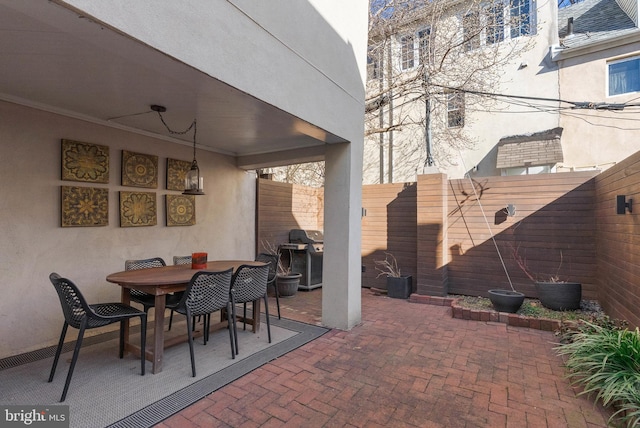 view of patio / terrace featuring a fenced backyard, a grill, and outdoor dining space