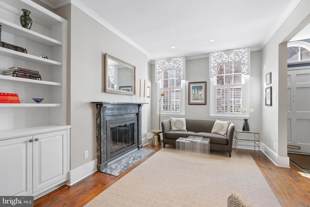 living room featuring plenty of natural light, dark wood-type flooring, and ornamental molding