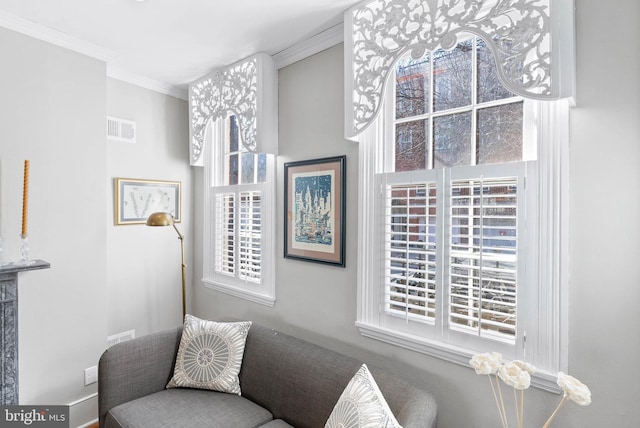 sitting room featuring visible vents and crown molding