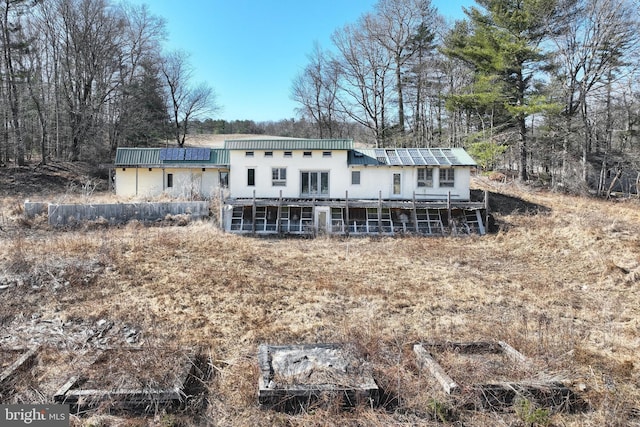 rear view of house featuring metal roof