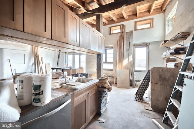 kitchen featuring open shelves, concrete flooring, and a sink