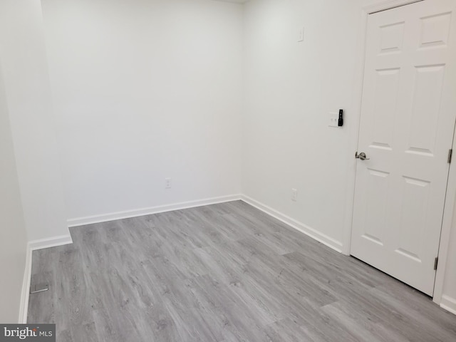 unfurnished room with baseboards and wood finished floors