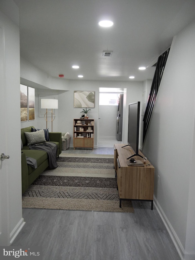 stairway featuring visible vents, recessed lighting, baseboards, and wood finished floors