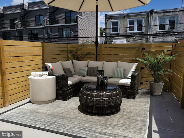 view of patio featuring outdoor lounge area and fence