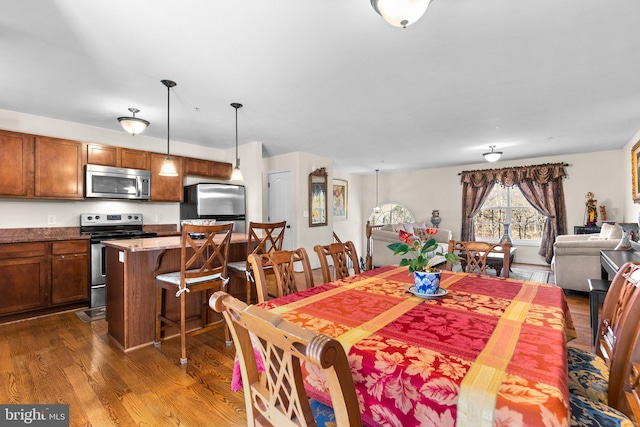 dining space featuring dark wood-type flooring