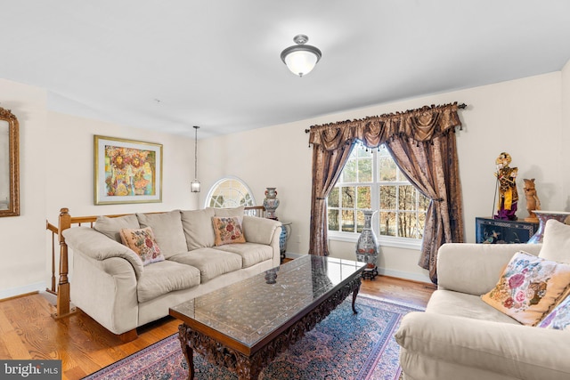 living area with wood finished floors and baseboards