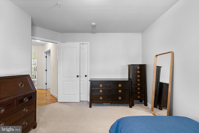 bedroom featuring light colored carpet