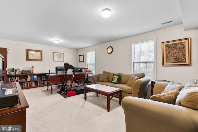 living area with visible vents and carpet floors