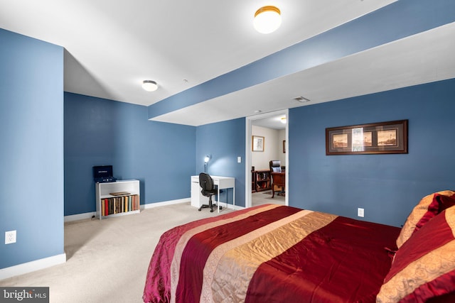 carpeted bedroom with visible vents and baseboards