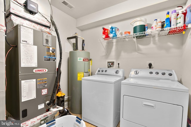 laundry room with washer and dryer, laundry area, visible vents, and water heater