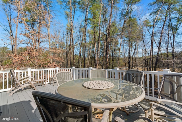 wooden terrace featuring outdoor dining area