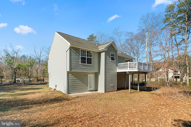 rear view of property with a wooden deck