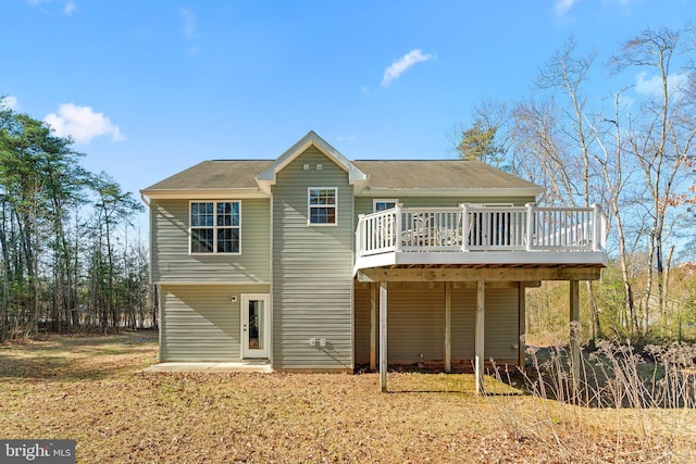 back of property featuring a wooden deck