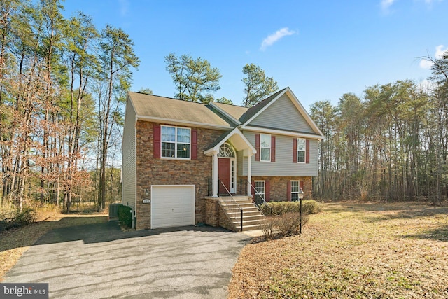 bi-level home featuring driveway and an attached garage