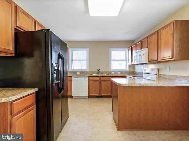 kitchen featuring a sink, white appliances, and brown cabinetry