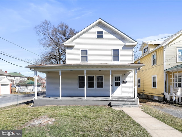 view of front of home featuring covered porch, a front lawn, and fence