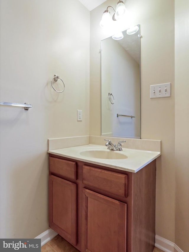 bathroom with vanity, tile patterned floors, and baseboards