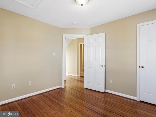 unfurnished bedroom featuring baseboards and wood-type flooring