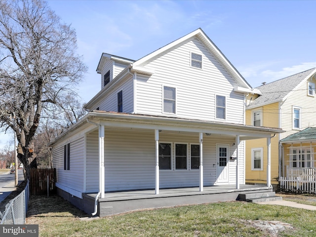 view of front of property with a porch and fence