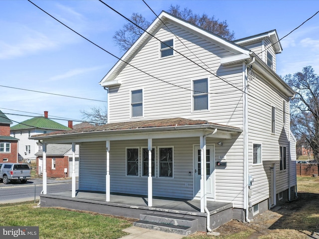 view of front of house featuring a porch and fence