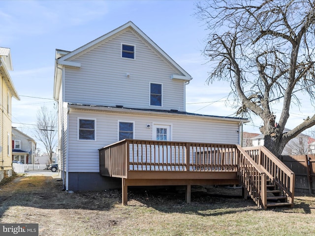 back of house with a deck and fence