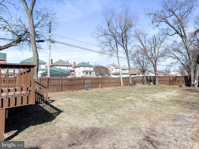 view of yard featuring a deck and a fenced backyard